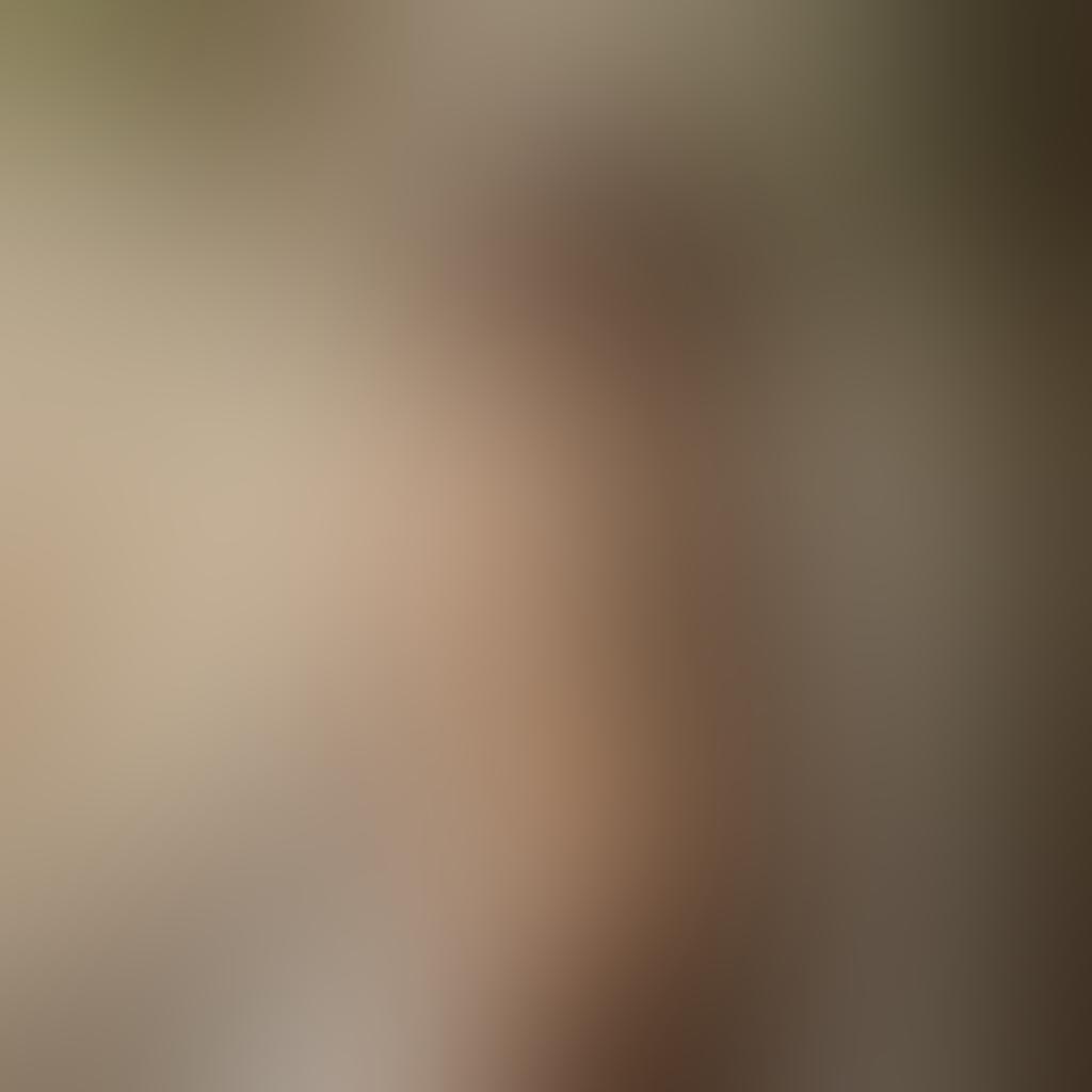 A captivating nude photograph featuring a model in a serene, natural setting, emphasizing the beauty of the human form and artistic expression. Soft, diffused lighting enhances the subject's curves while surrounding elements like flowing fabric or delicate flowers add depth and inspiration. The composition should evoke a sense of tranquility and creativity, inviting viewers to engage with the art. Consider contrasting textures between the skin and nature for a striking visual effect. super-realistic. warm tones. soft background.