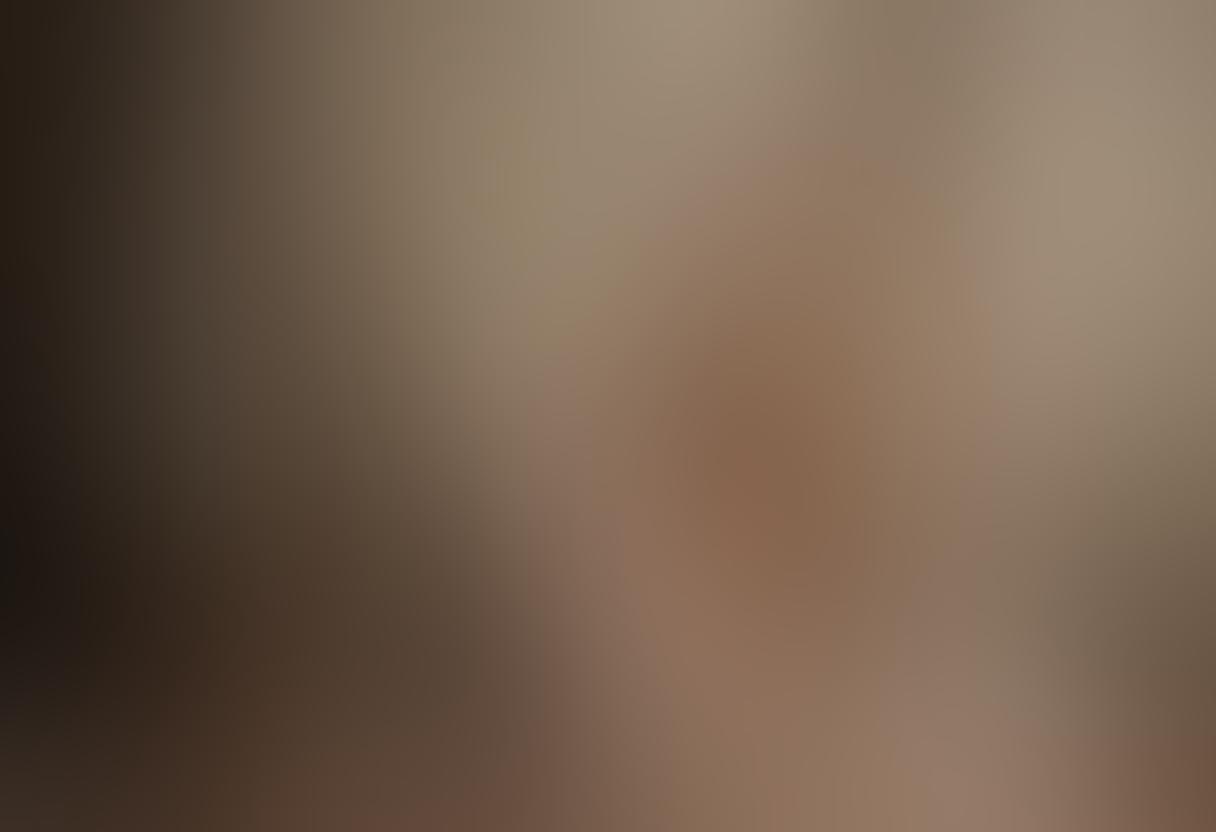 A serene and evocative scene of an intimate nude photography session, featuring a soft-lit studio with elegant drapery and artistic props. The model poses gracefully, conveying emotions of vulnerability and confidence, while the photographer captures the moment with a vintage camera. Warm, muted tones enhance the atmosphere, symbolizing the connection between art and intimacy. super-realistic. soft lighting. warm colors.